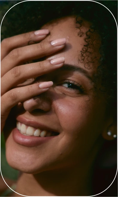 Woman smiling with hand on her face